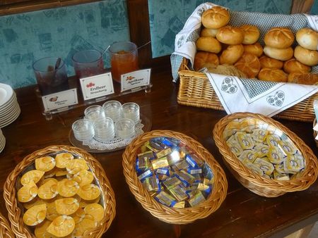 Breakfast photo with bread, rolls and various small spreads